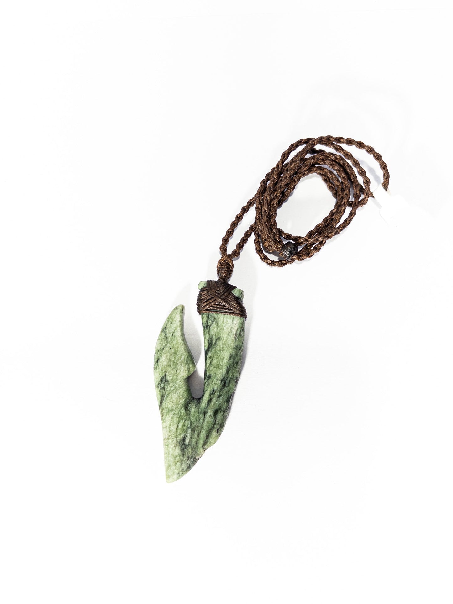 Pounamu Fishhook on plain background
