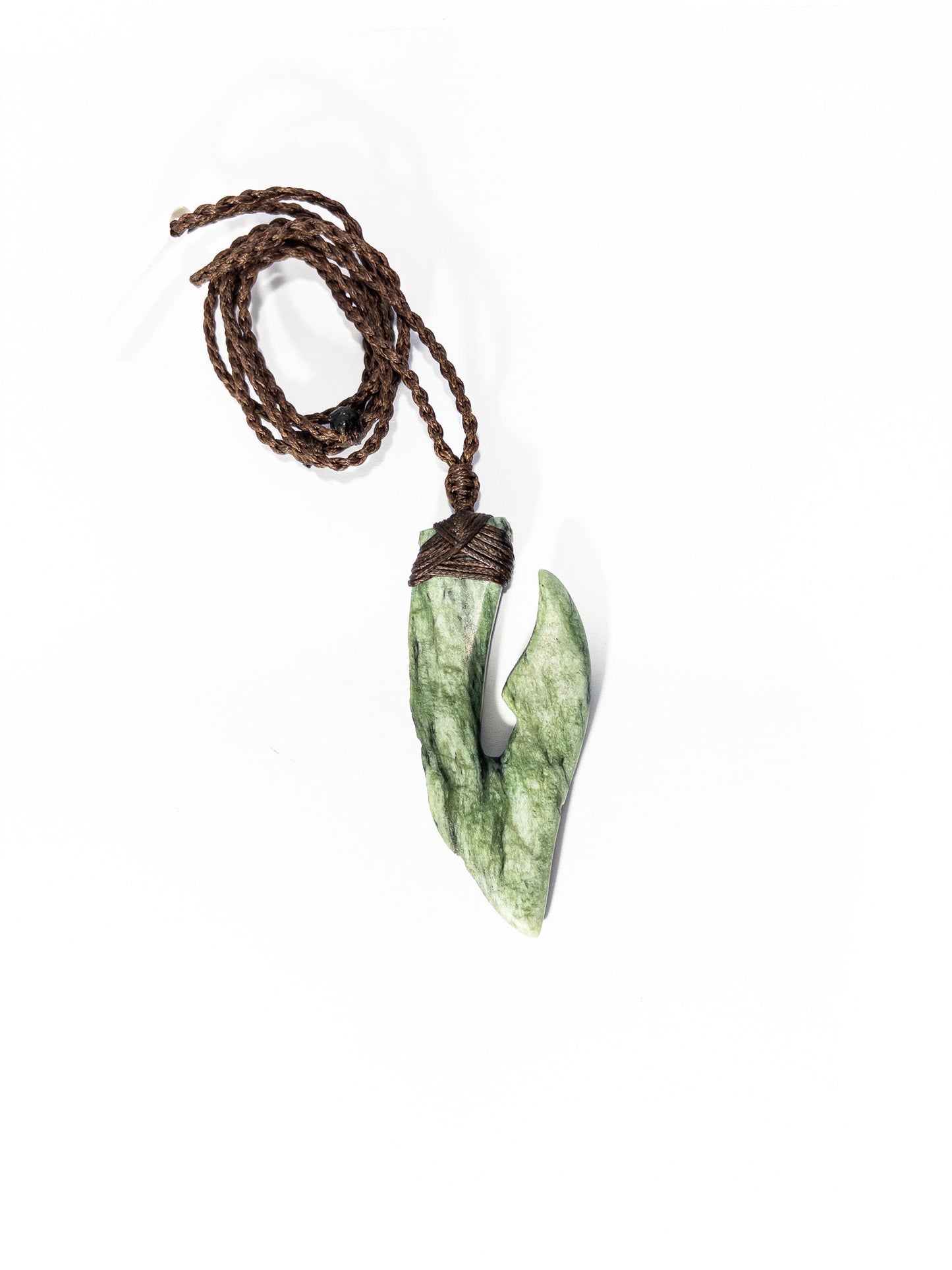 Pounamu Fishhook on plain background