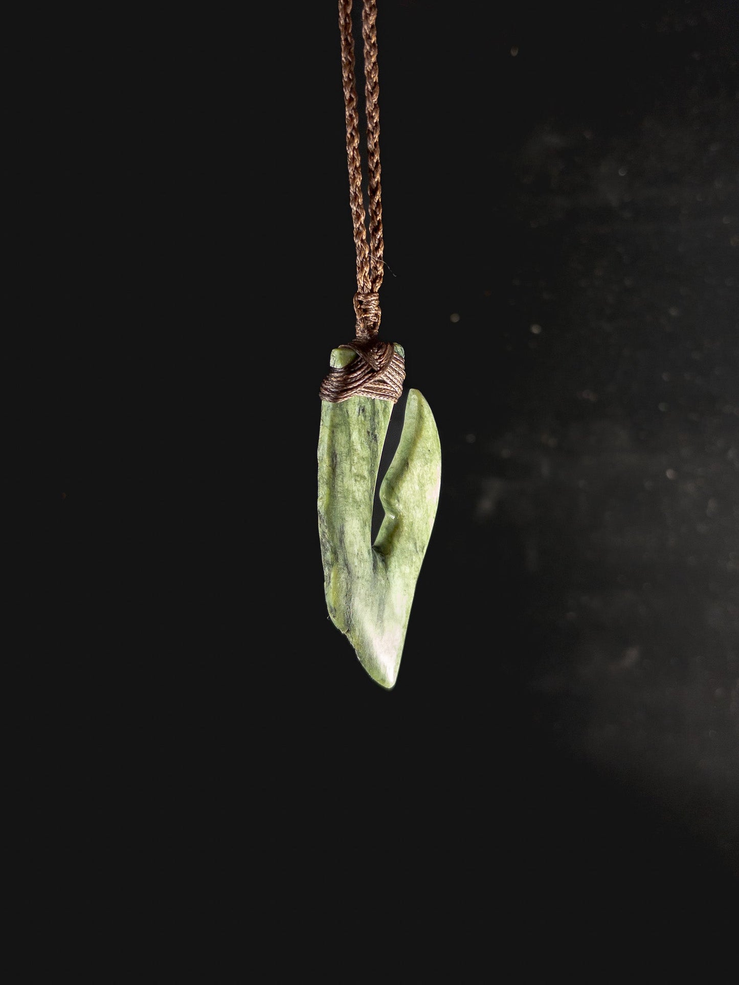 Pounamu Fishhook on plain background