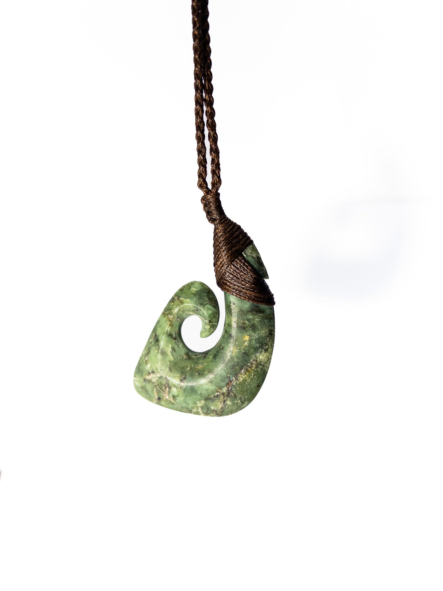 Pounamu Fishhook on plain background