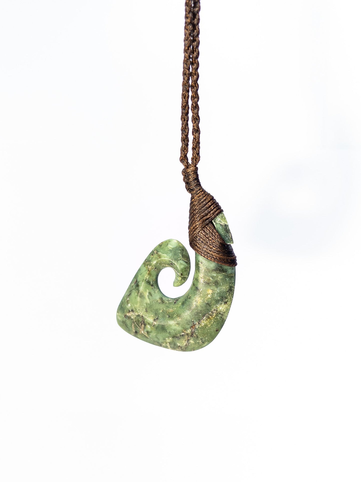 Pounamu Fishhook on plain background