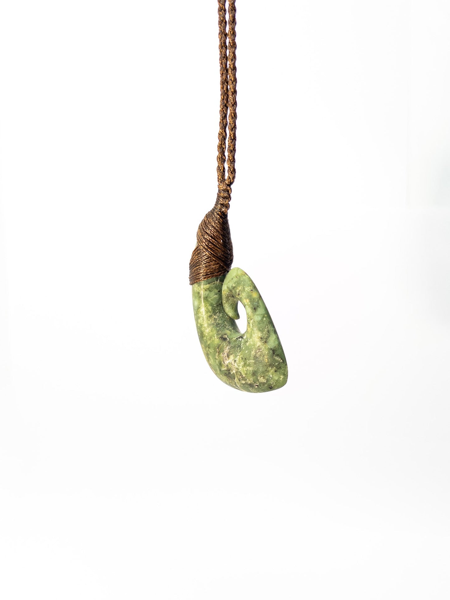 Pounamu Fishhook on plain background