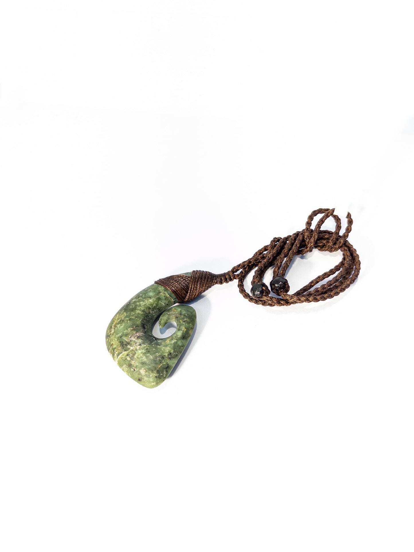 Pounamu Fishhook on plain background