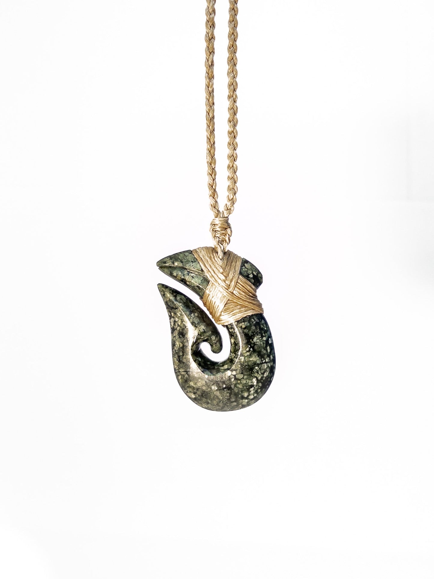Pounamu Fishhook on plain background