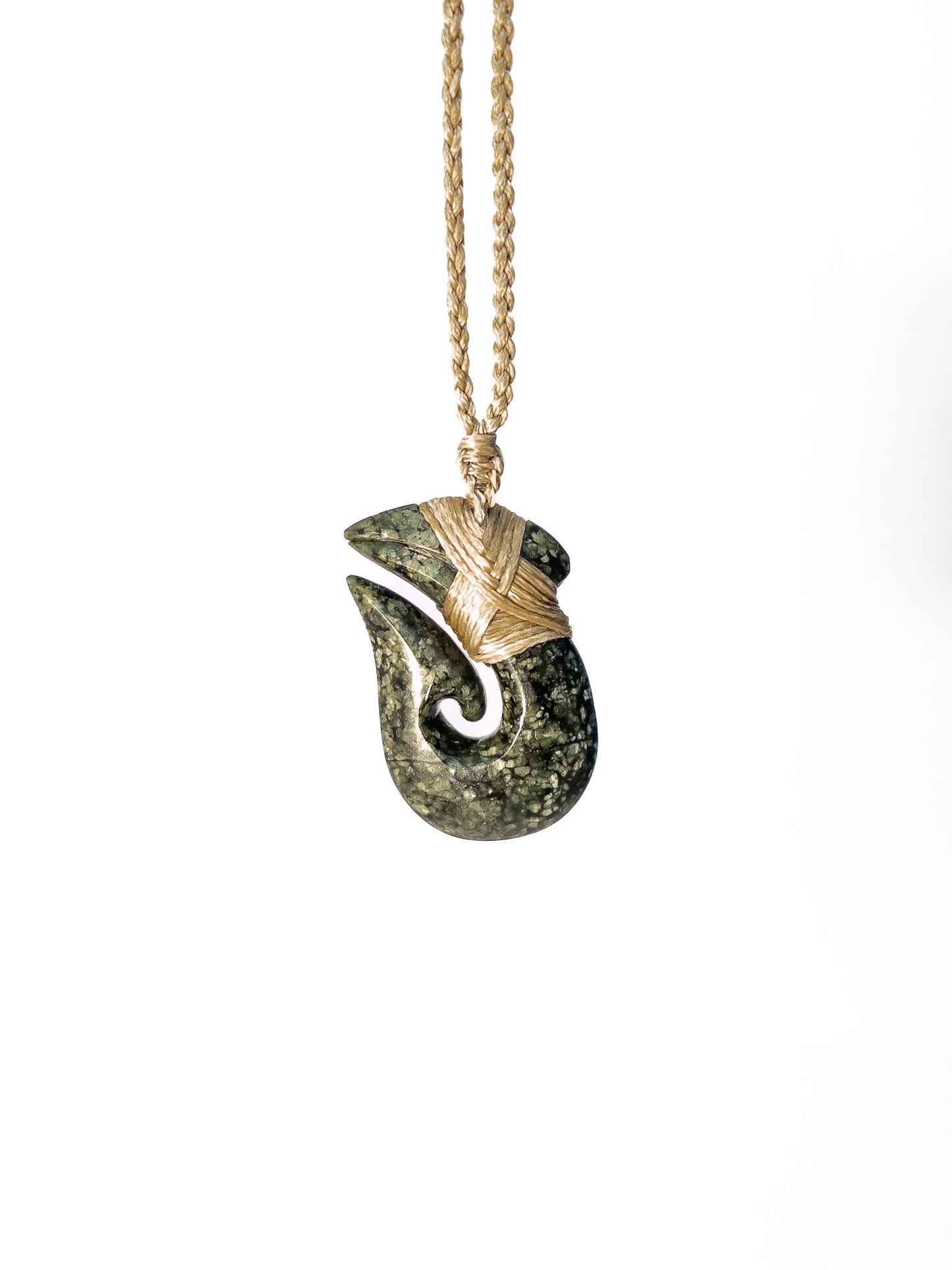 Pounamu Fishhook on plain background