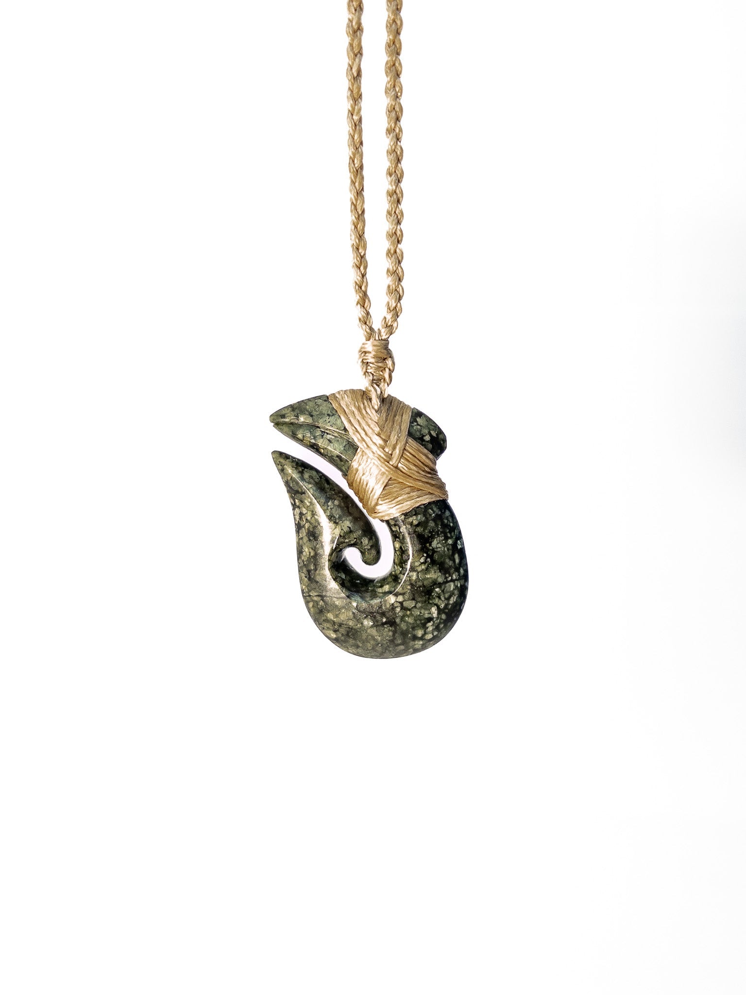 Pounamu Fishhook on plain background