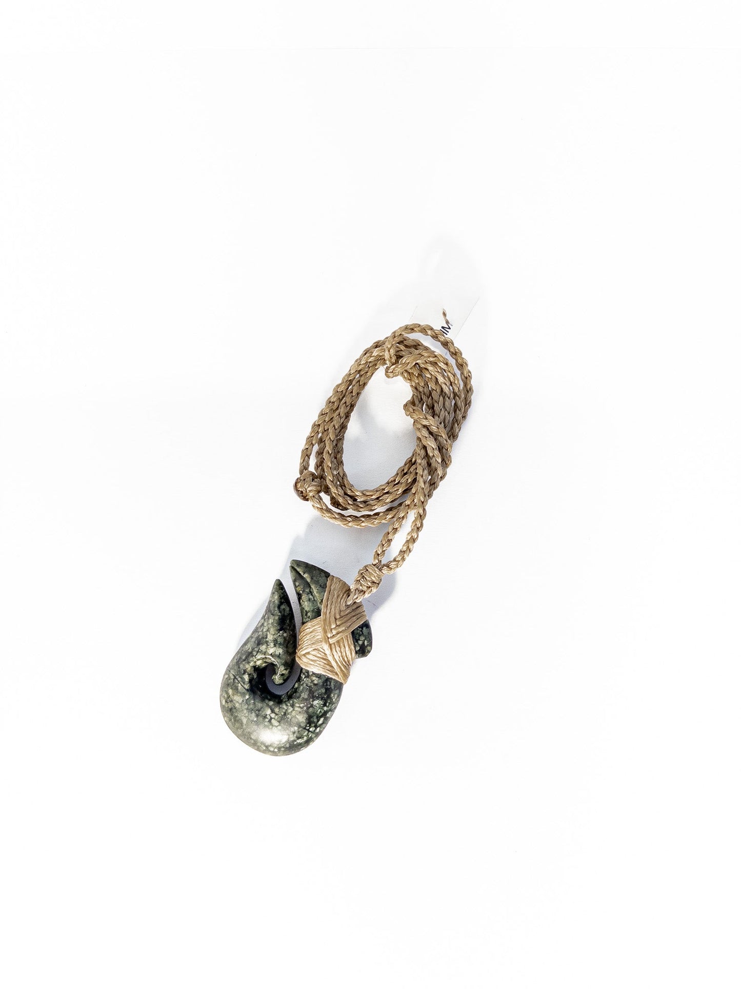 Pounamu Fishhook on plain background