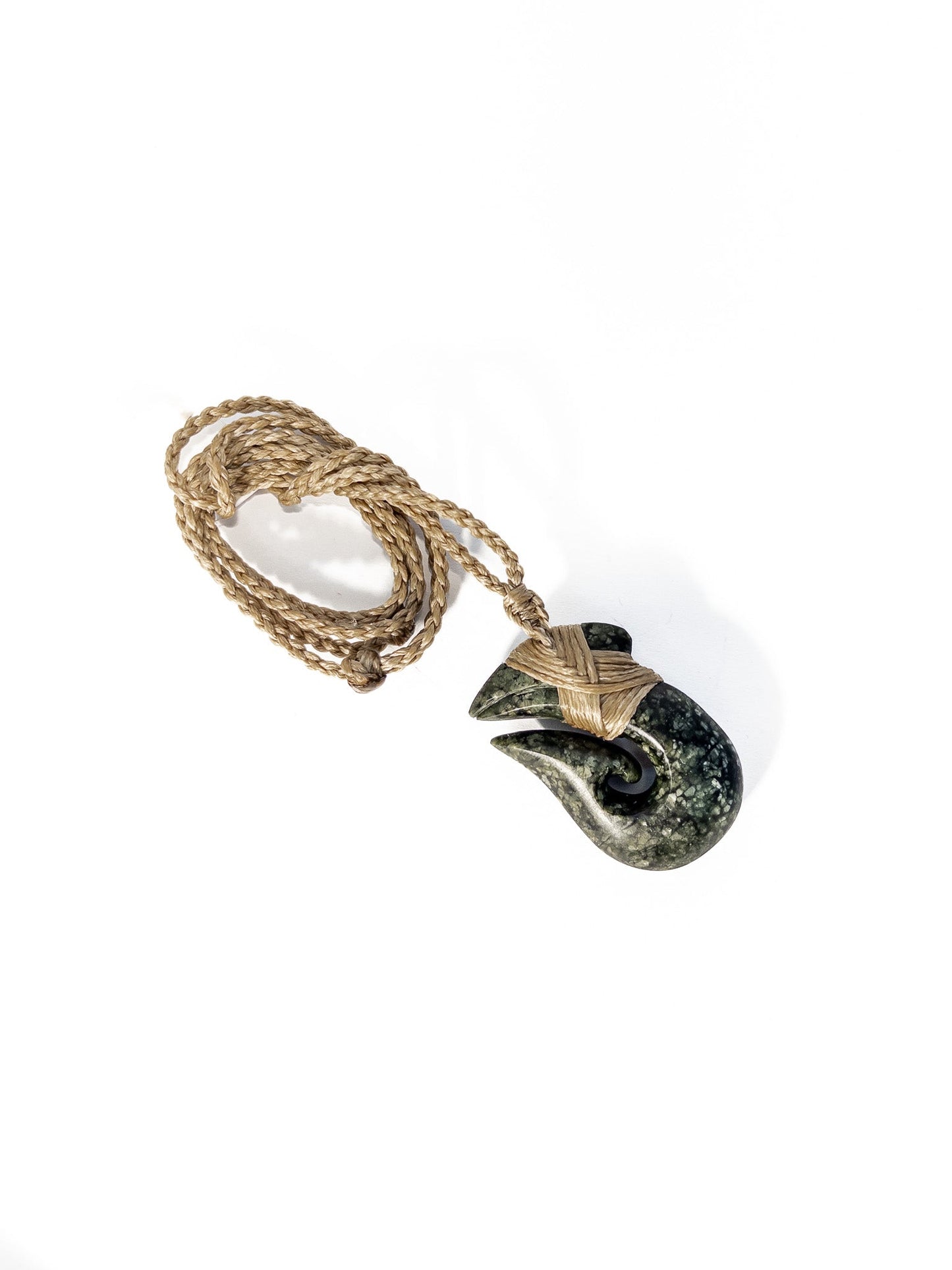 Pounamu Fishhook on plain background