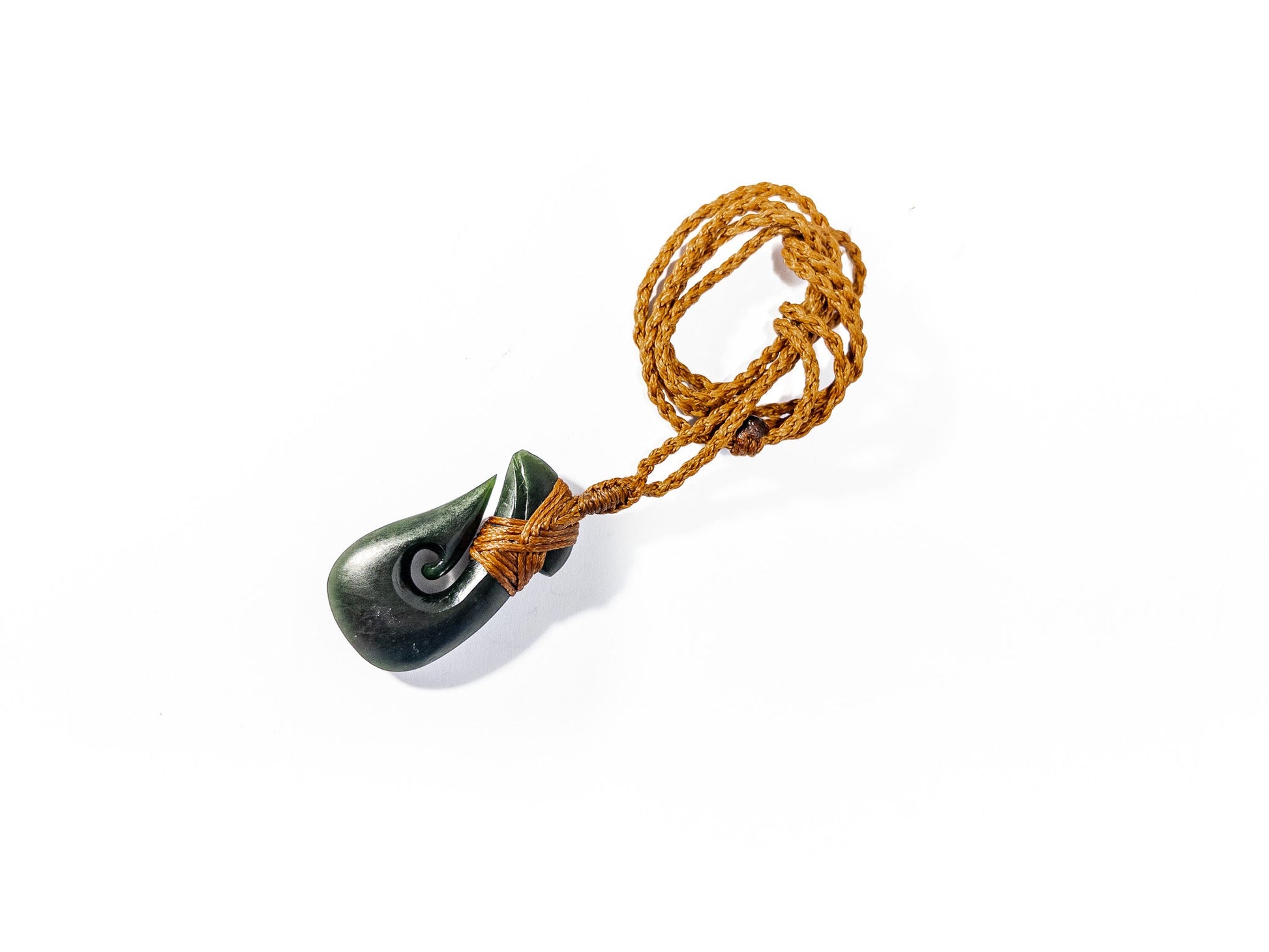 Pounamu Fishhook on plain background