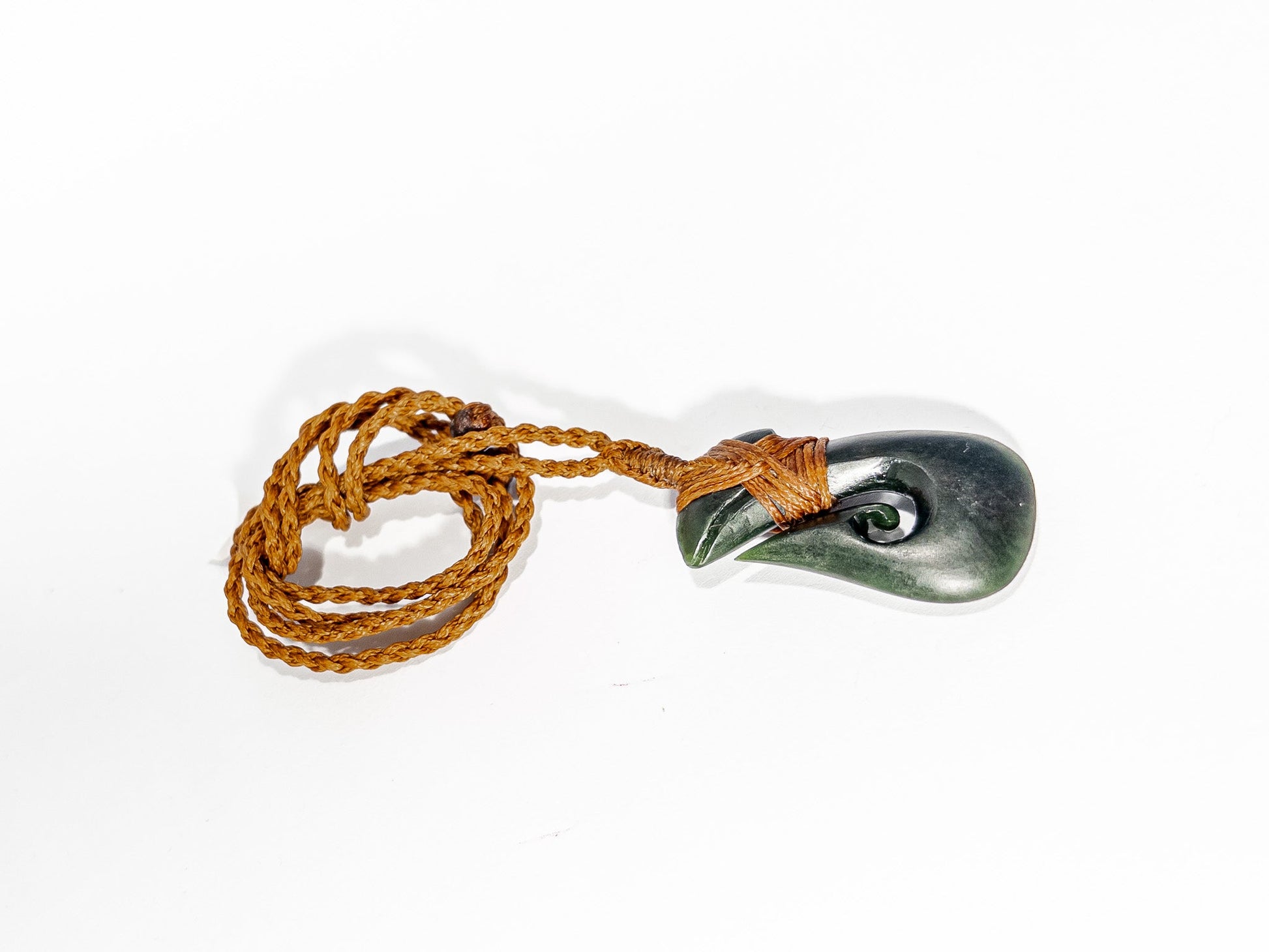 Pounamu Fishhook on plain background