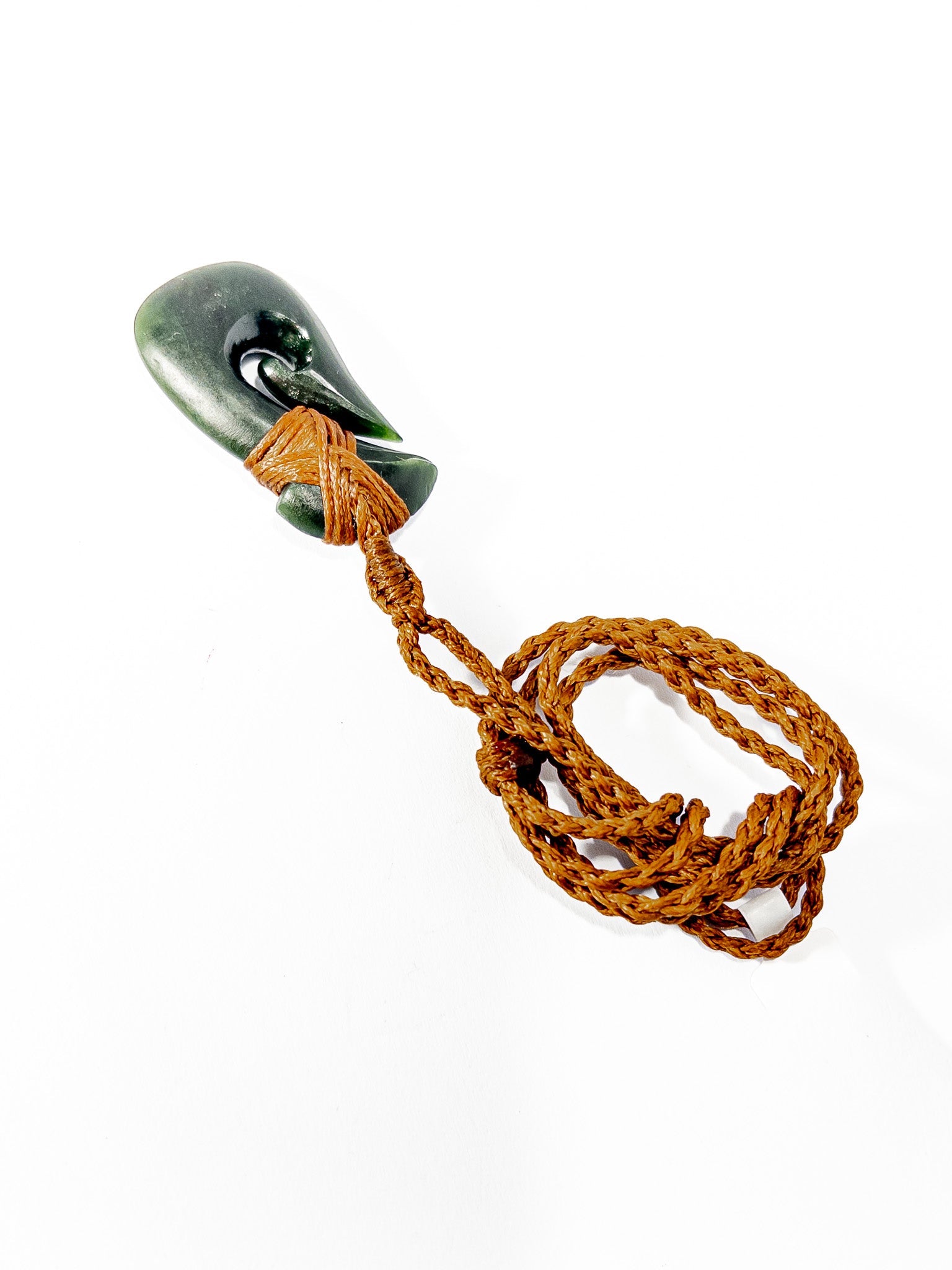 Pounamu Fishhook on plain background