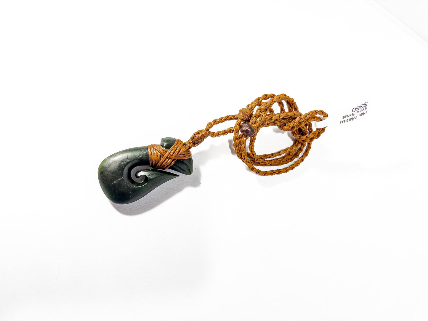 Pounamu Fishhook on plain background