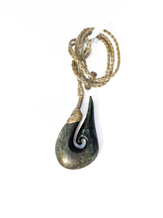 Pounamu Fishhook on plain background