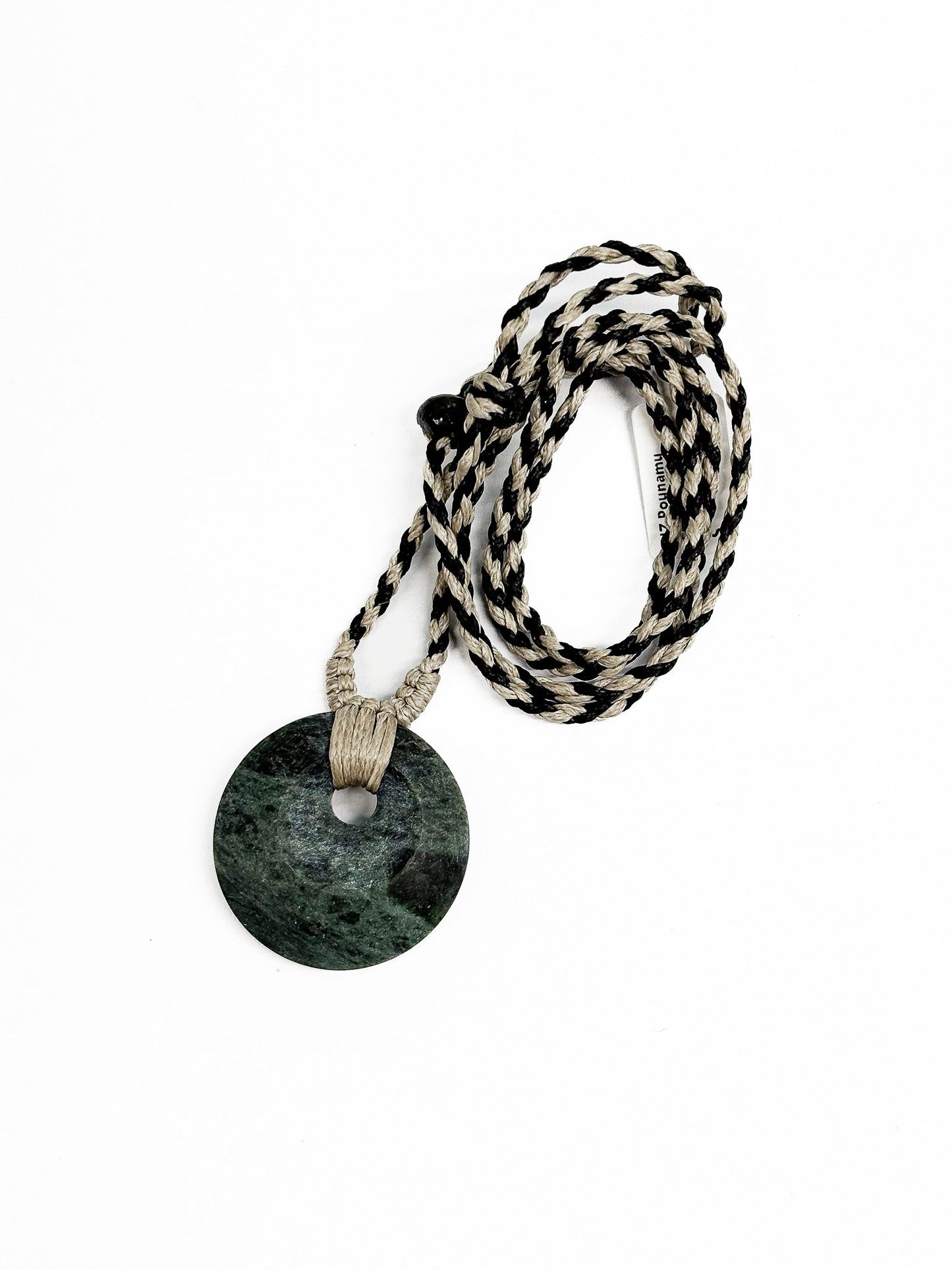 Circle of Life or Porowhita pounamu twist pendant on Black background