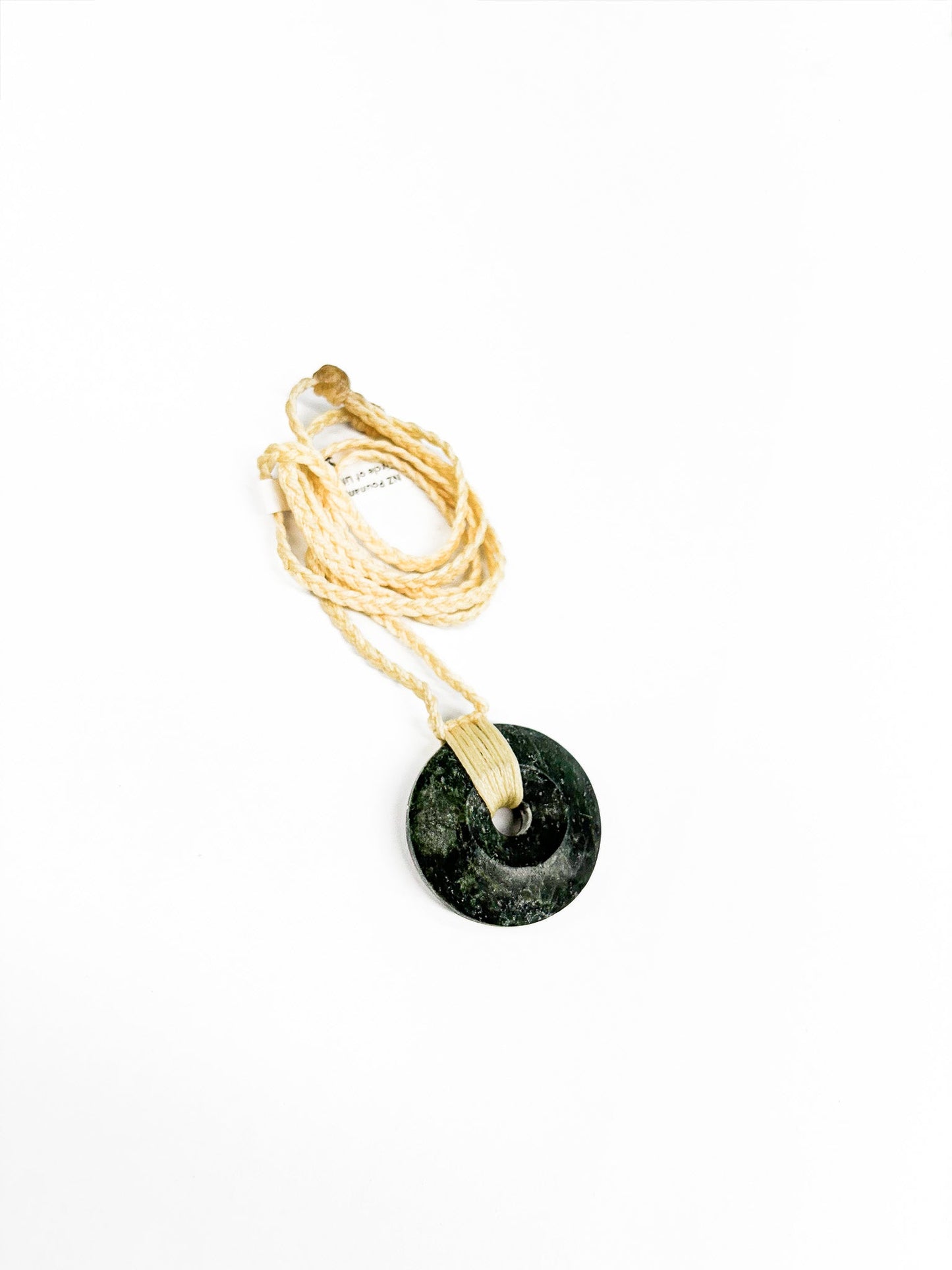 Circle of Life or Porowhita pounamu twist pendant on Black background