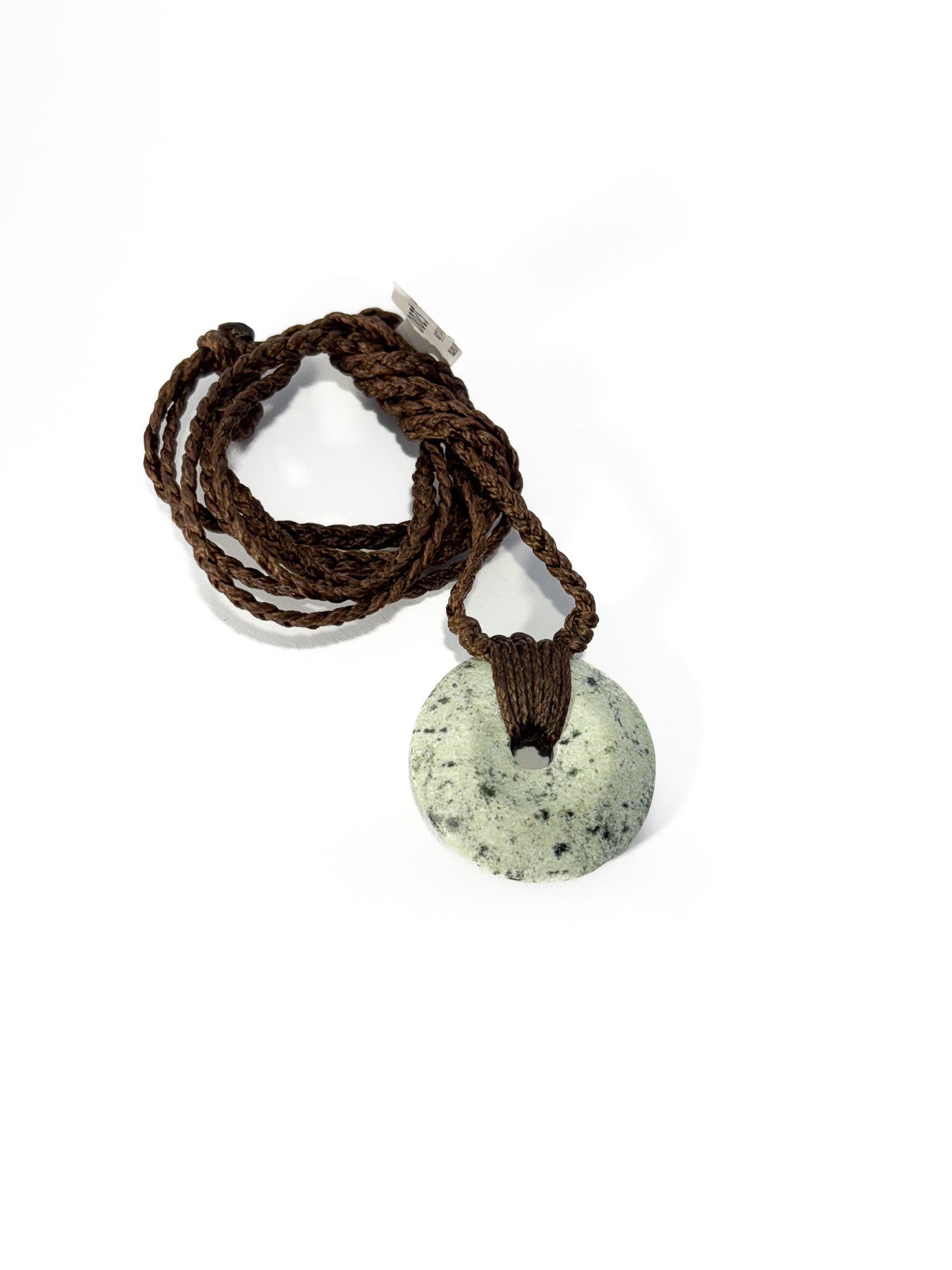 Circle of Life or Porowhita pounamu twist pendant on Black background