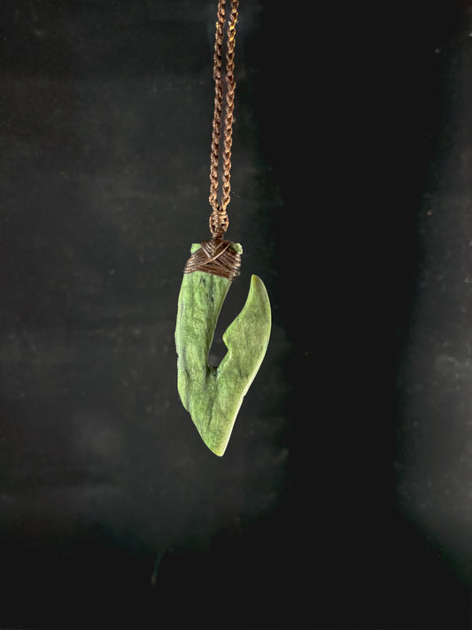 Pounamu Fishhook on plain background