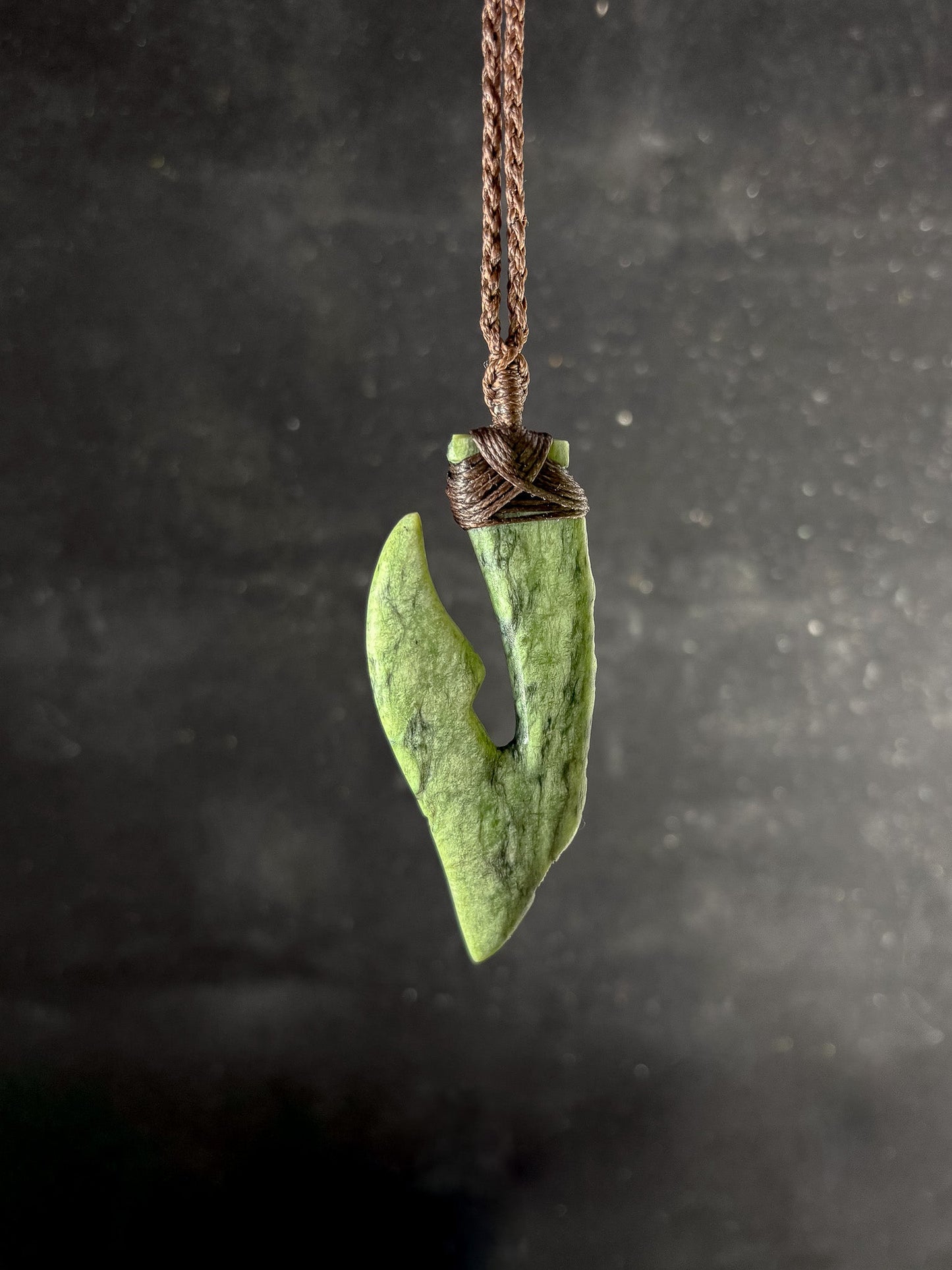 Pounamu Fishhook on plain background