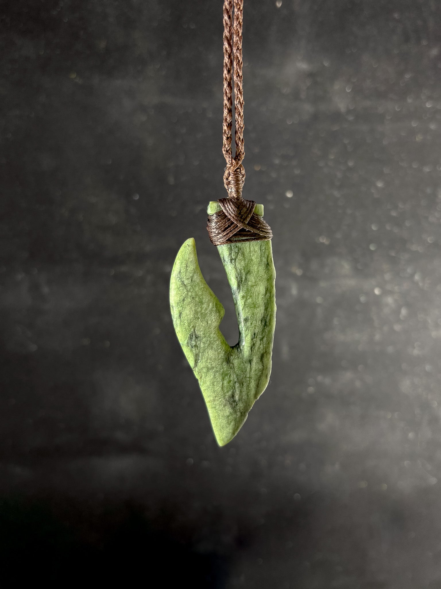 Pounamu Fishhook on plain background