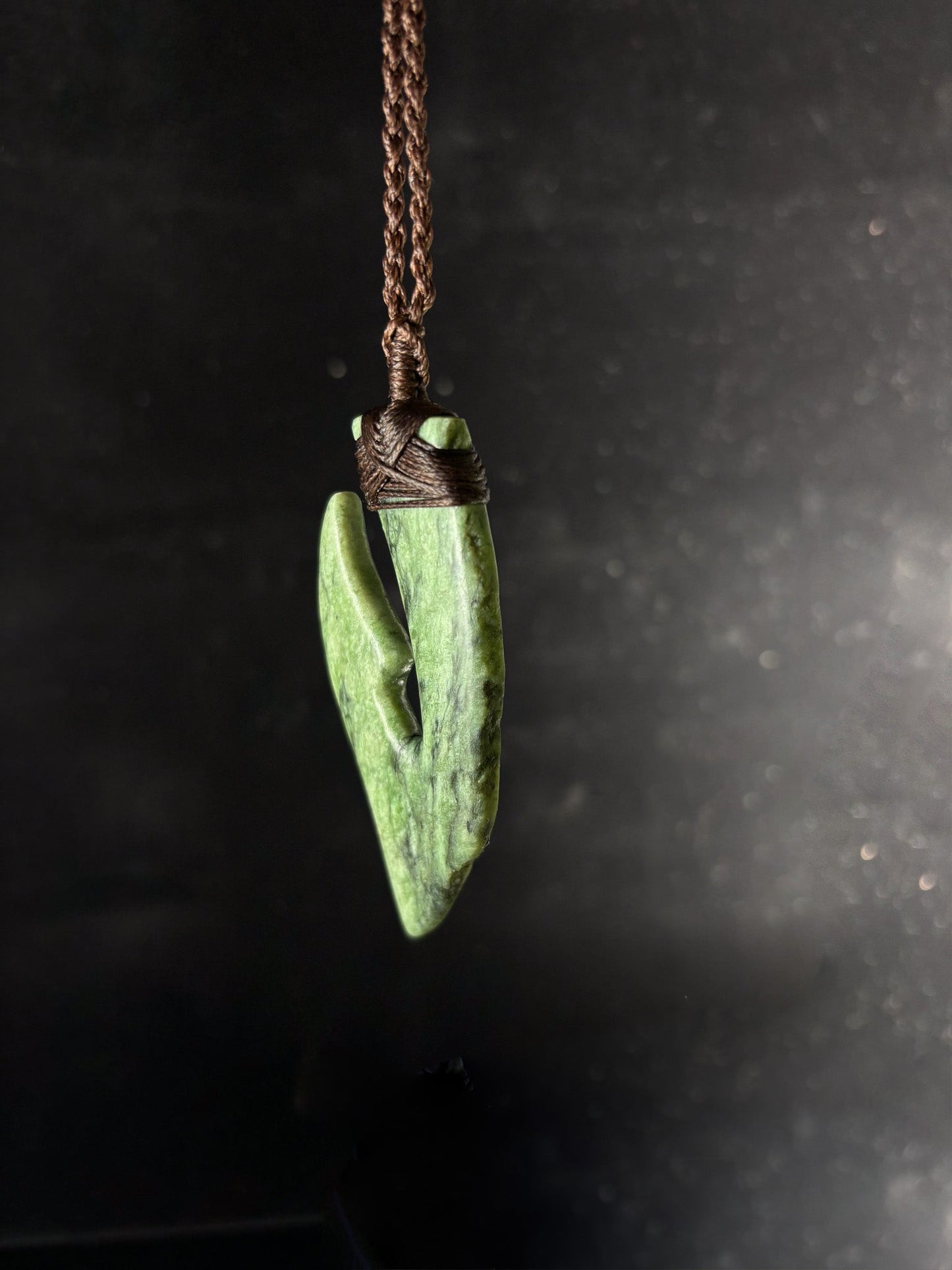 Pounamu Fishhook on plain background