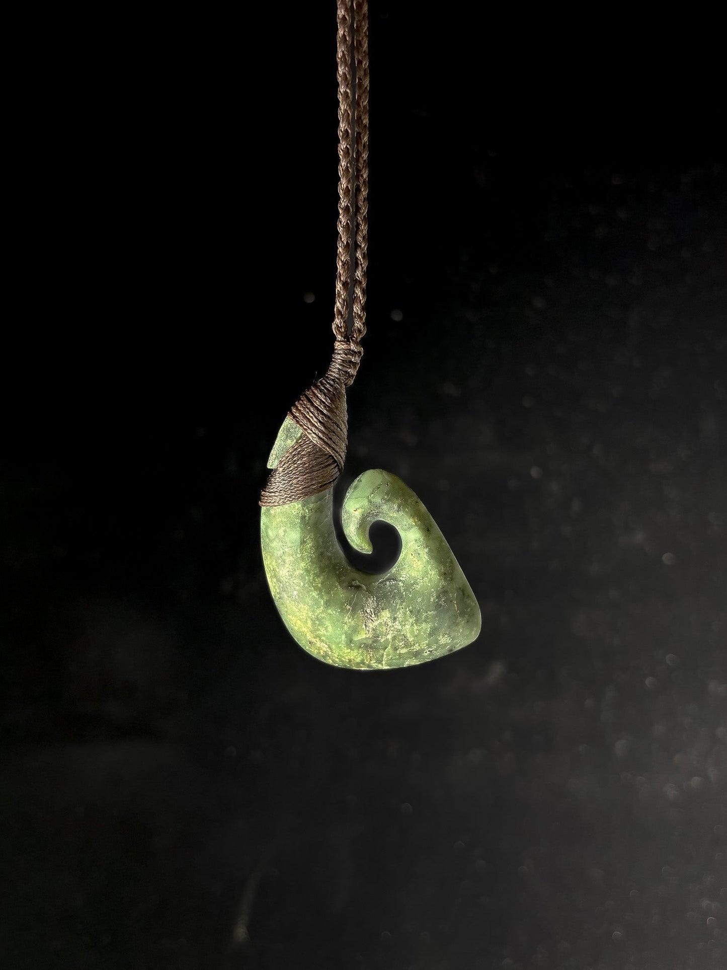 Pounamu Fishhook on plain background