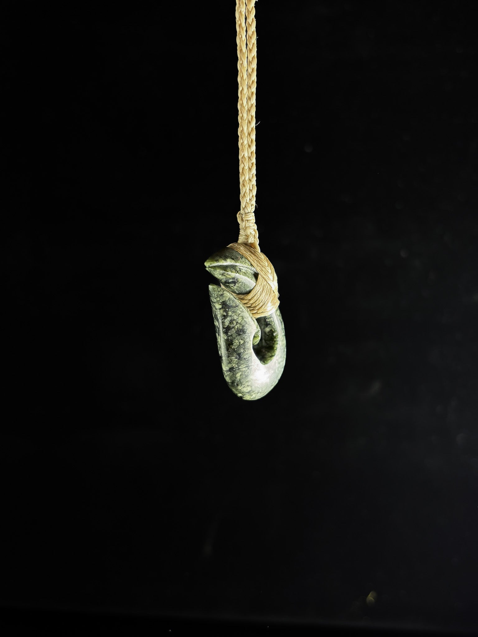 Pounamu Fishhook on plain background