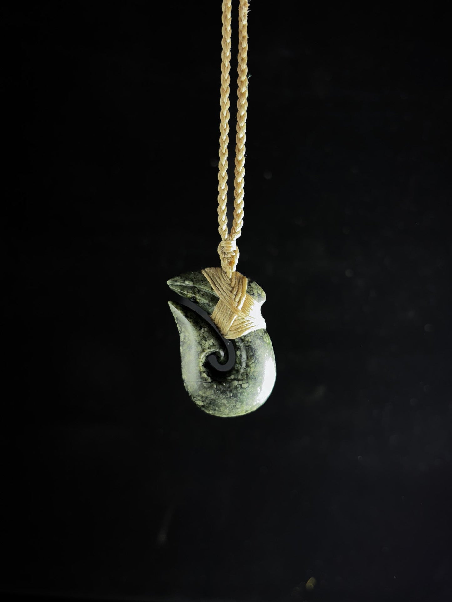 Pounamu Fishhook on plain background