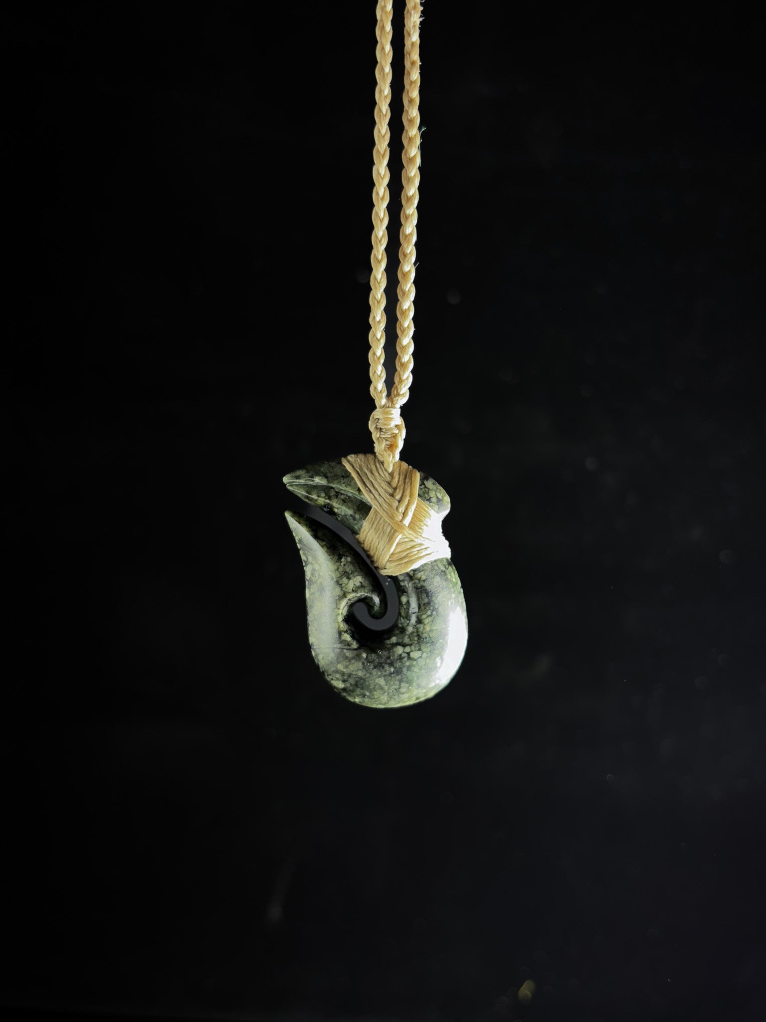Pounamu Fishhook on plain background