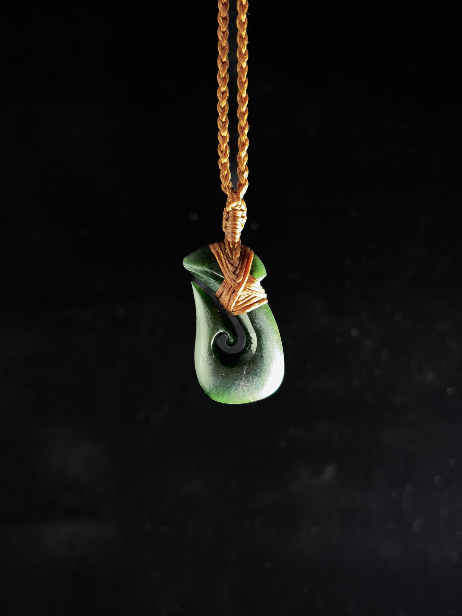 Pounamu Fishhook on plain background
