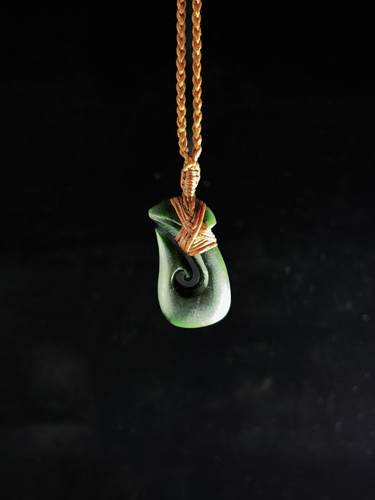 Pounamu Fishhook on plain background