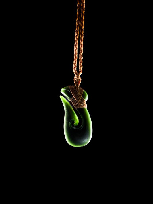 Pounamu Fishhook on plain background