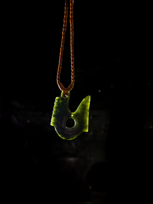 Pounamu Hei matau Fish hook on plain background