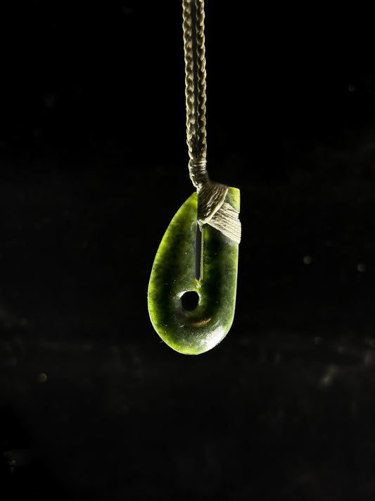 Pounamu Hei matau Fish hook on plain background