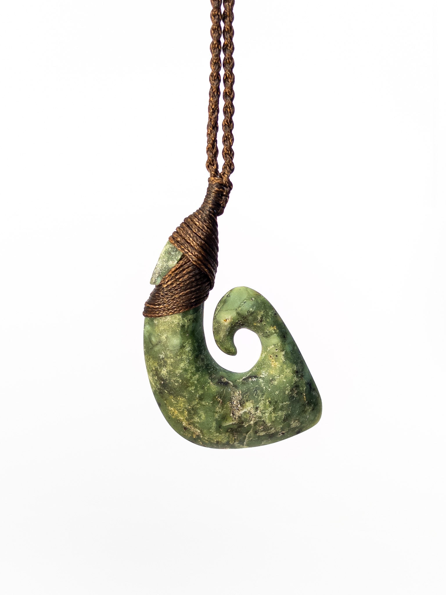 Pounamu Fishhook on plain background