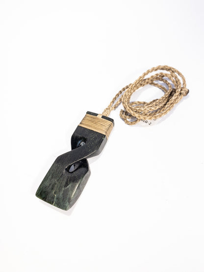 Pounamu pendant on plain background