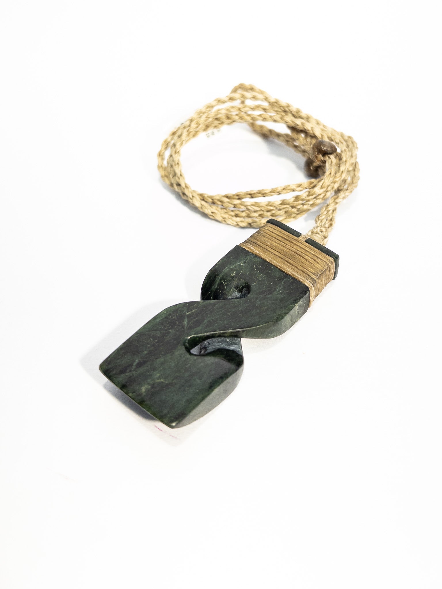 Pounamu pendant on plain background