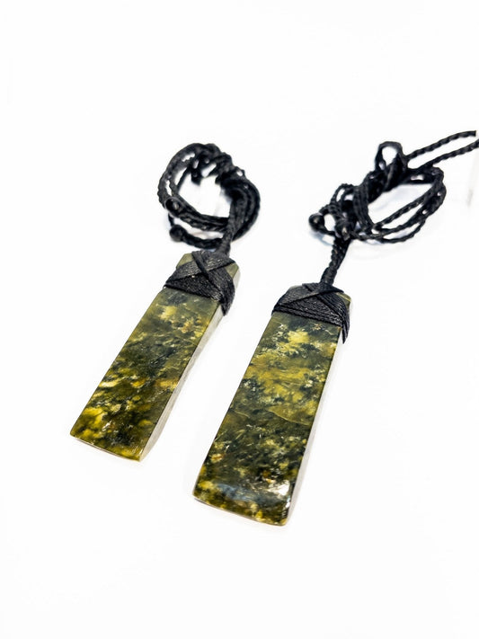 Pounamu pendants on plain background