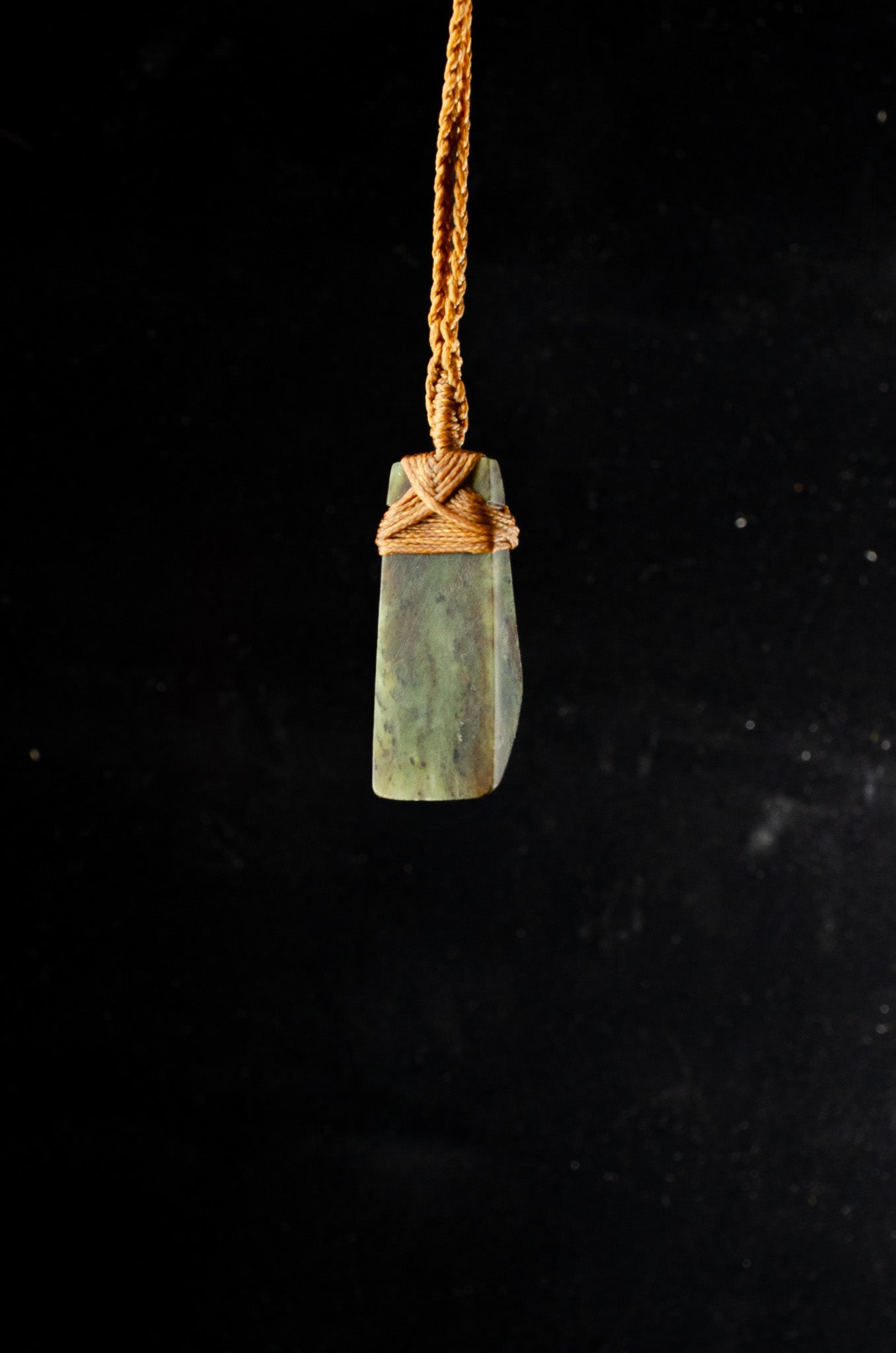 Pounamu pendant on plain background