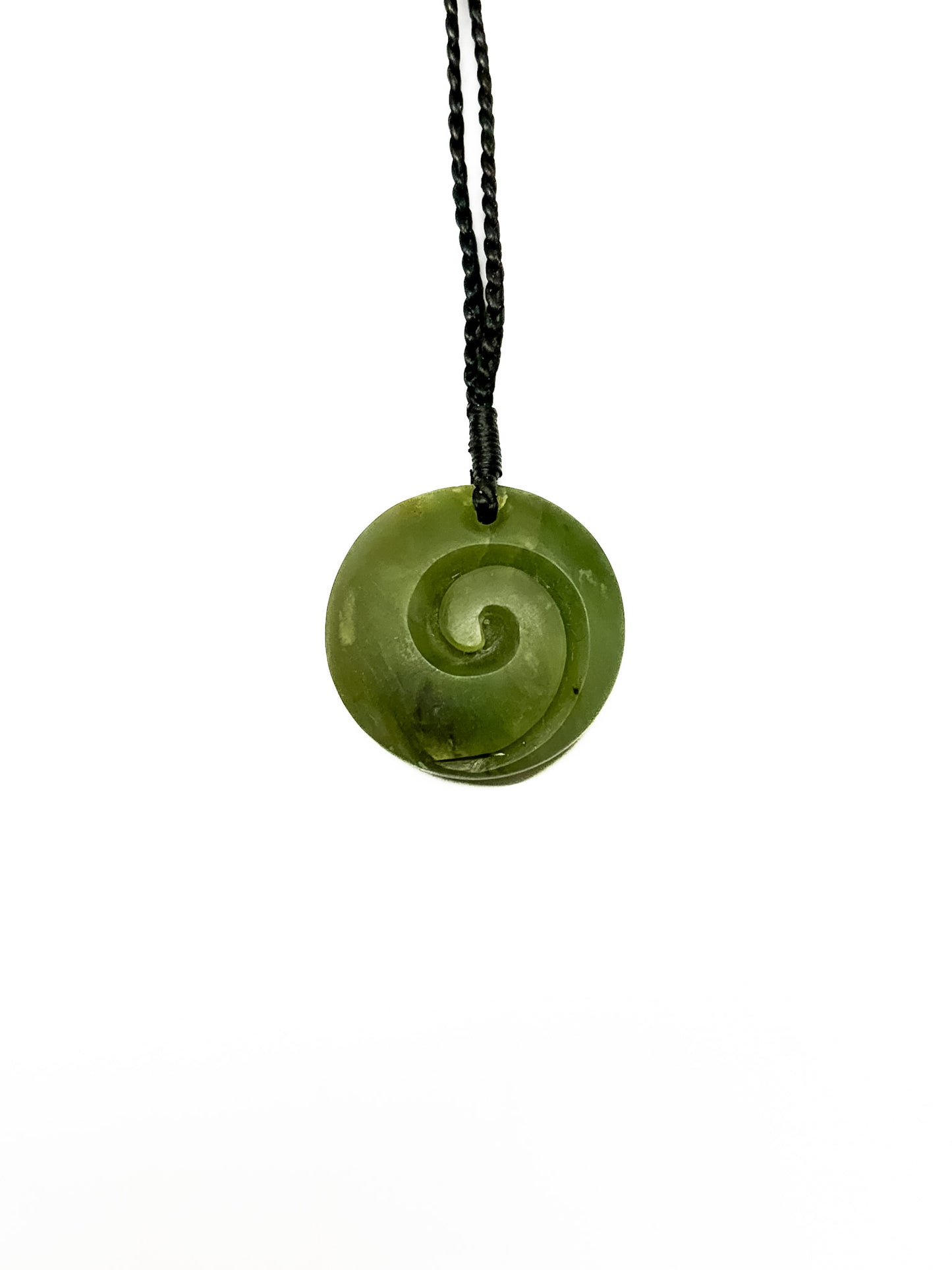 Pounamu koru pendant on white background