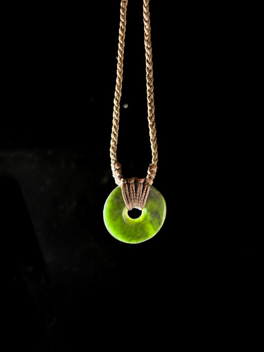 Circle of Life or Porowhita pounamu twist pendant on Black background