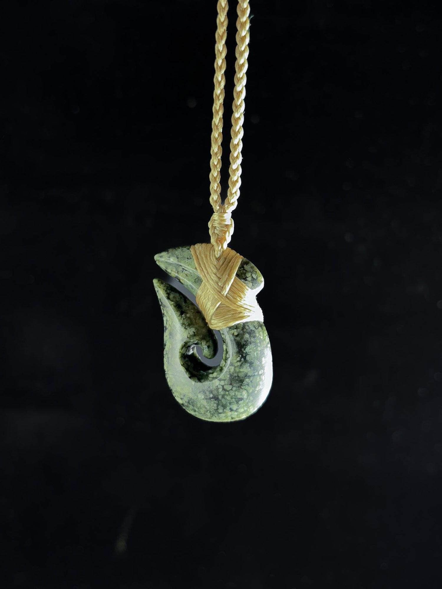 Pounamu Fishhook on plain background