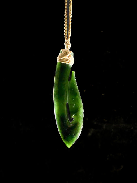 Pounamu Fishhook on plain background