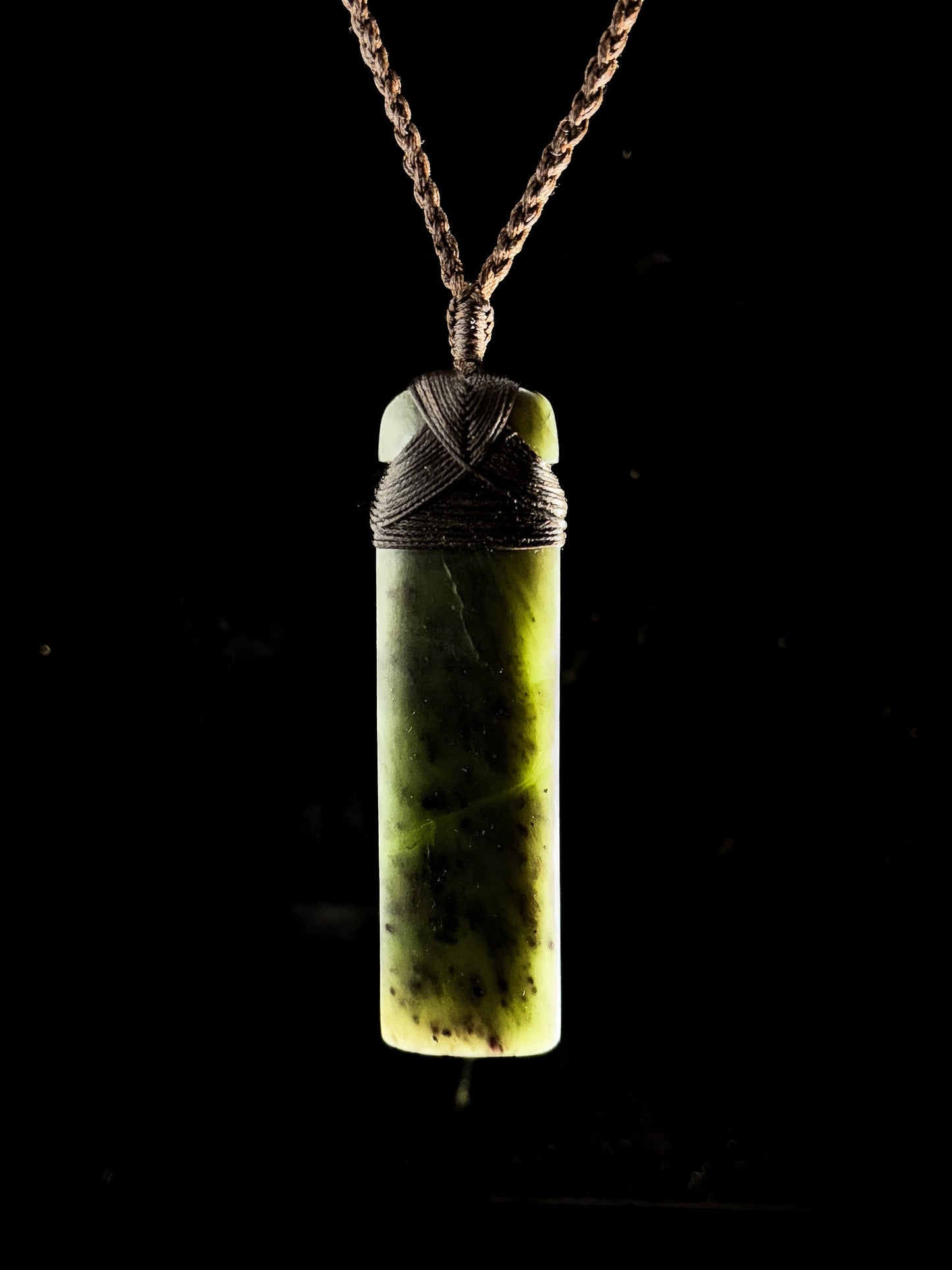 Pounamu pendant on plain background